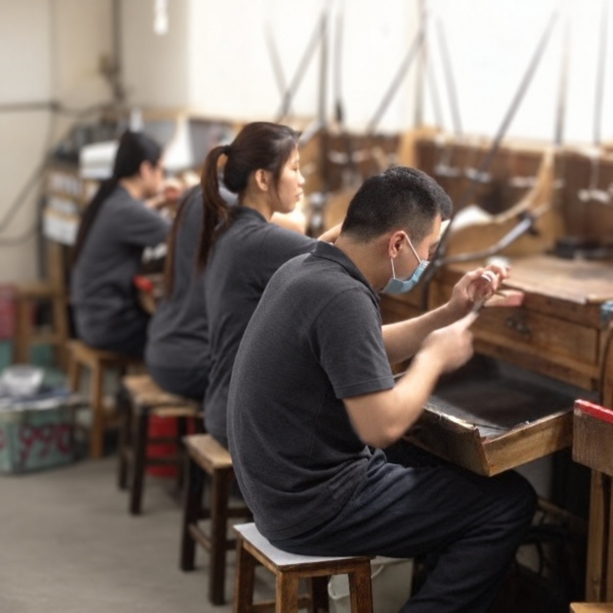 Jewellery makers at a production workbench