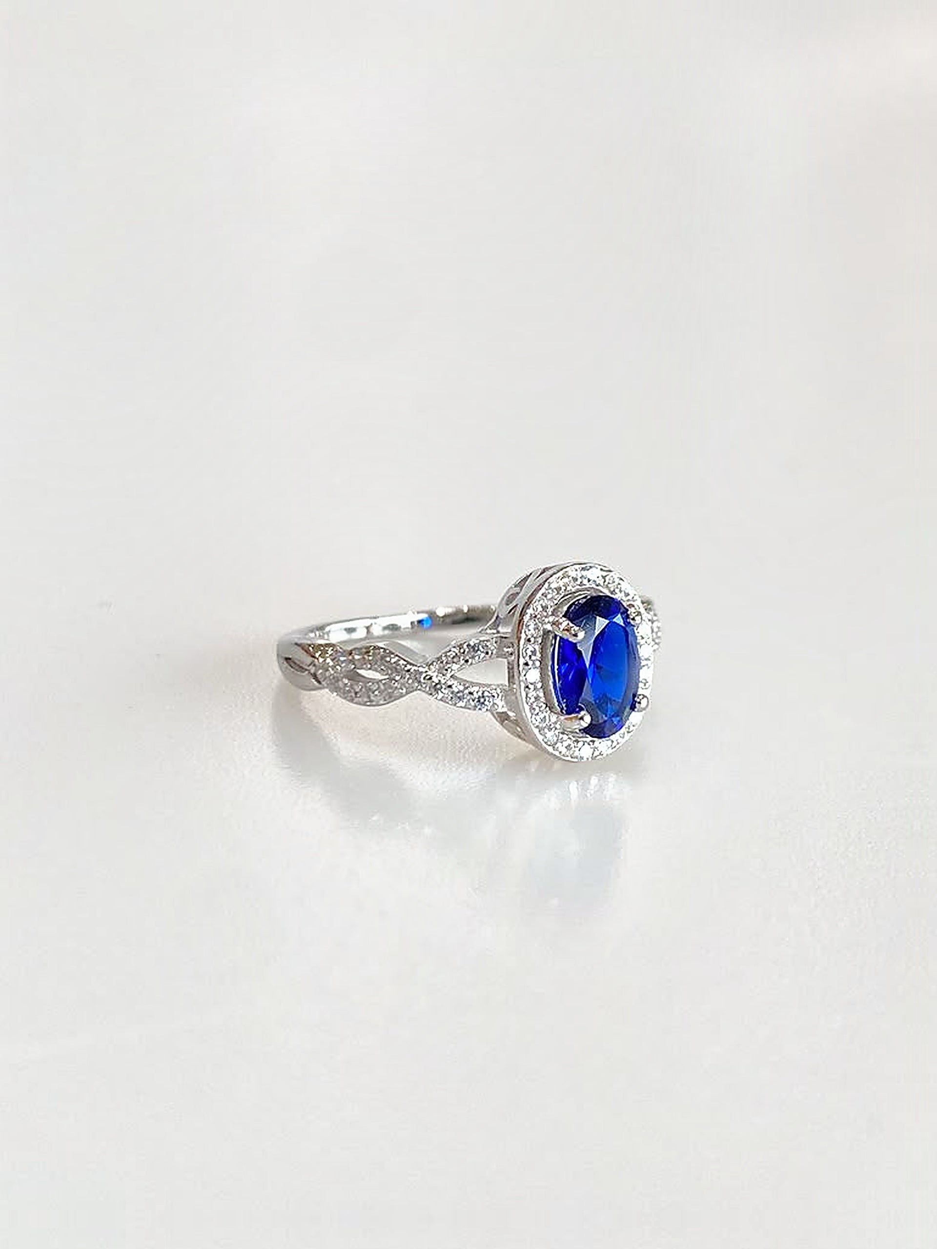 Josephine Oval Halo Ring (Deep Blue) - angled view